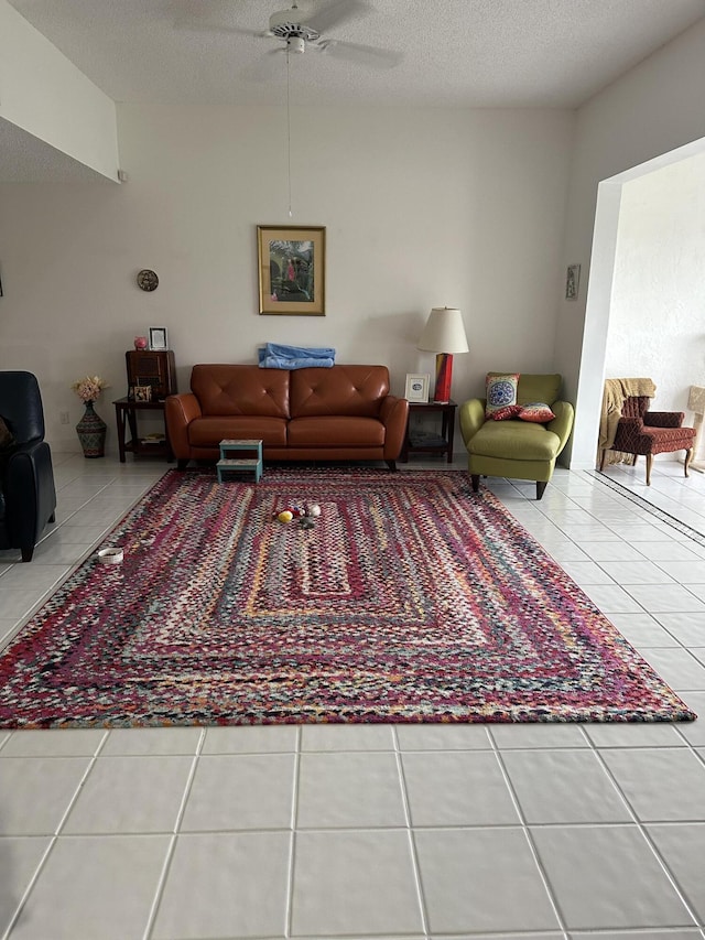 living room with ceiling fan and tile patterned flooring