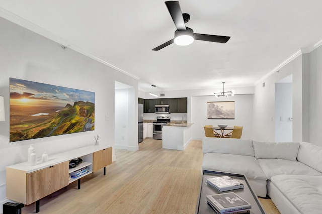 living room with ceiling fan with notable chandelier, light hardwood / wood-style flooring, and crown molding