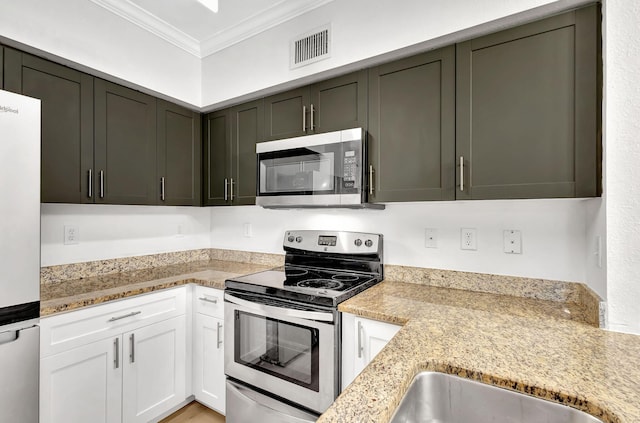 kitchen featuring light stone counters, sink, white cabinets, appliances with stainless steel finishes, and crown molding