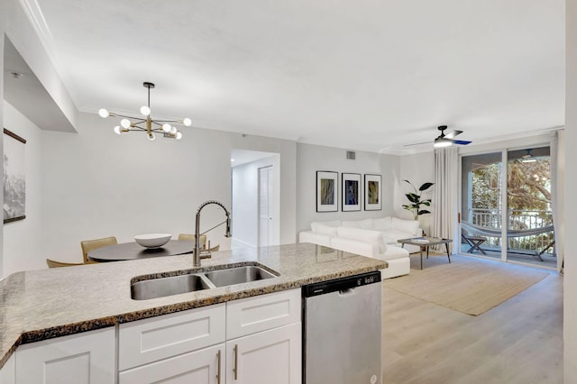 kitchen featuring dishwasher, light hardwood / wood-style floors, sink, white cabinetry, and hanging light fixtures