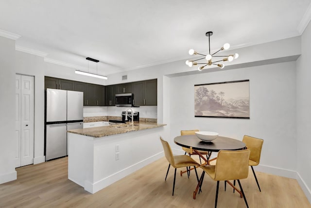 dining area with light hardwood / wood-style flooring, a chandelier, and ornamental molding