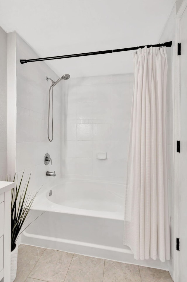 bathroom featuring tile patterned flooring, shower / bathtub combination with curtain, and vanity