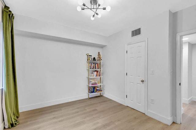 interior space with an inviting chandelier and light wood-type flooring