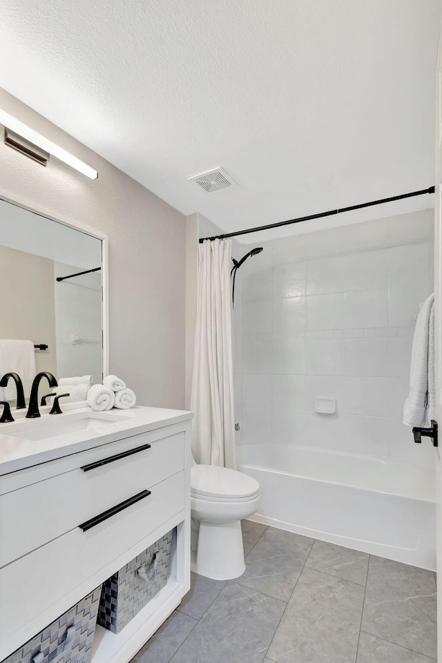 full bathroom featuring shower / bath combination with curtain, a textured ceiling, tile patterned floors, vanity, and toilet