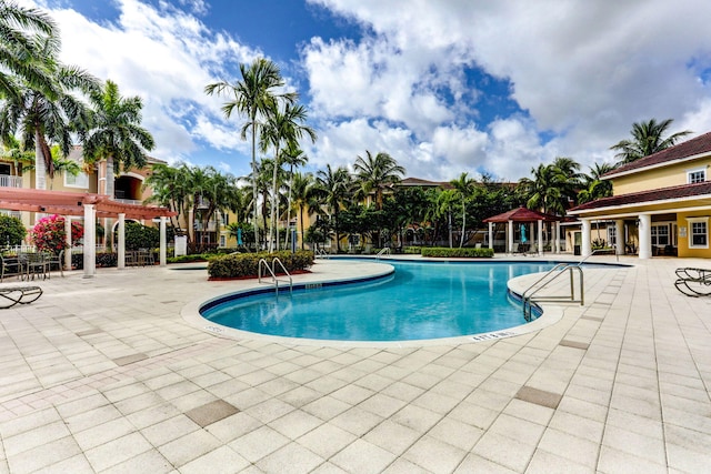 view of swimming pool with a pergola and a patio