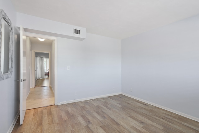 unfurnished room featuring light hardwood / wood-style floors