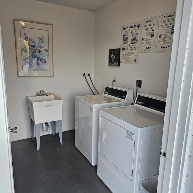 clothes washing area featuring sink and washing machine and dryer