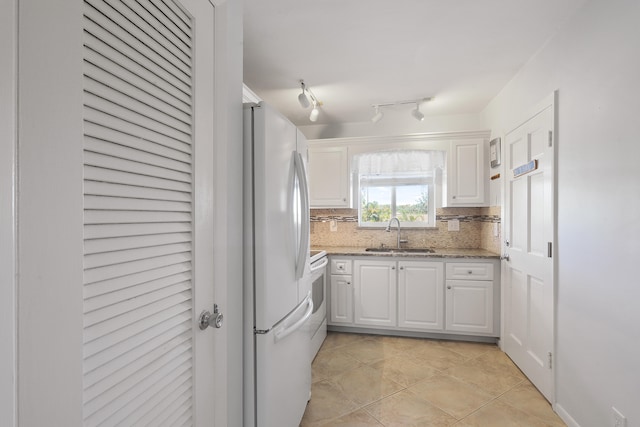 kitchen with sink, white cabinets, decorative backsplash, light stone counters, and white appliances