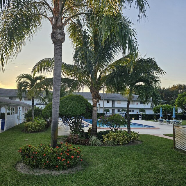 view of community with a beach view and a deck with water view