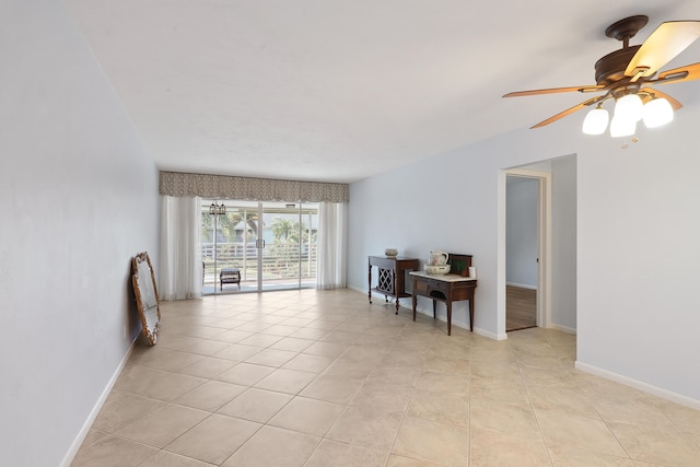 tiled spare room with ceiling fan