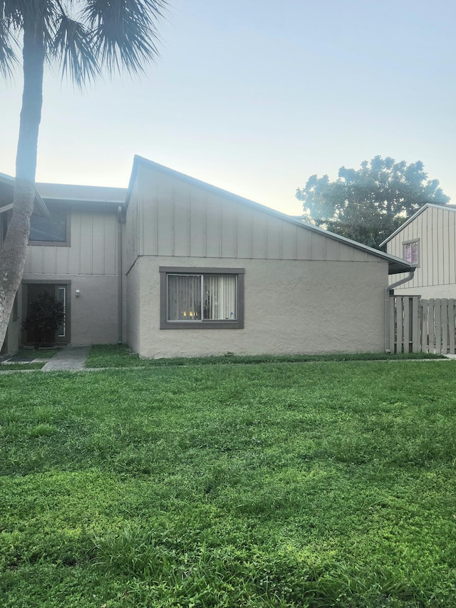 view of home's exterior with a lawn