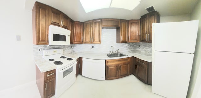 kitchen featuring light countertops, white appliances, backsplash, and visible vents