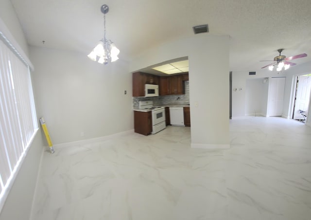 kitchen featuring marble finish floor, tasteful backsplash, light countertops, open floor plan, and white appliances