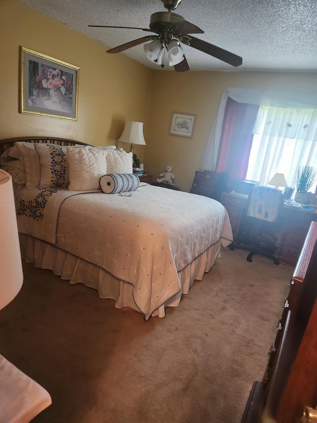 carpeted bedroom featuring a textured ceiling and ceiling fan