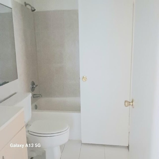 full bathroom with toilet, vanity, tiled shower / bath, and tile patterned flooring