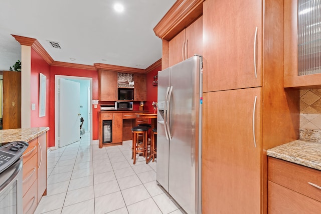 kitchen featuring appliances with stainless steel finishes, decorative backsplash, crown molding, and light stone countertops