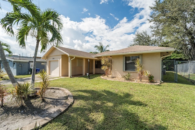 single story home featuring a garage and a front lawn