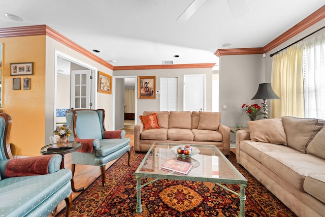 living room featuring ceiling fan, vaulted ceiling, and ornamental molding