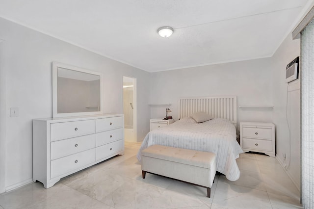 bedroom featuring a wall mounted air conditioner and ensuite bathroom