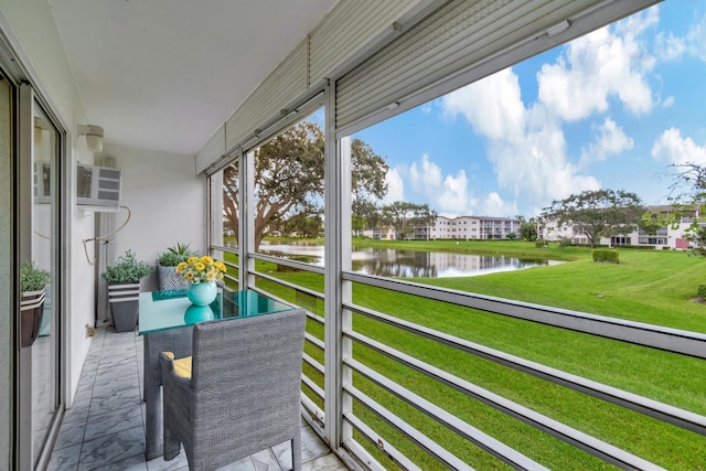 balcony with a water view and a wall mounted AC