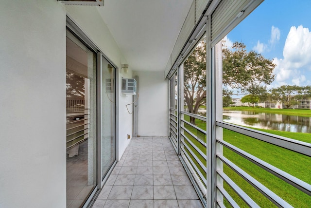 balcony with a wall unit AC and a water view