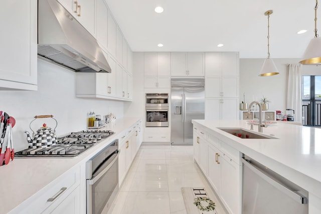 kitchen with light tile patterned floors, white cabinetry, sink, pendant lighting, and stainless steel appliances