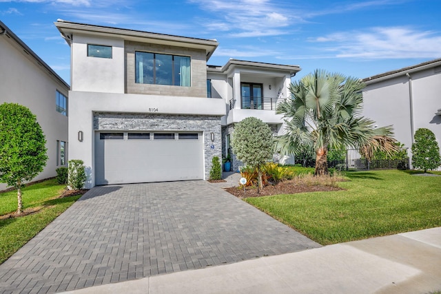 contemporary house with a balcony, a garage, and a front lawn