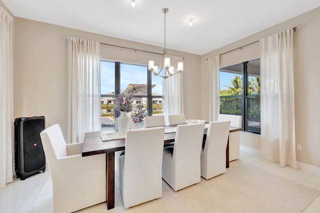 dining space featuring an inviting chandelier and plenty of natural light