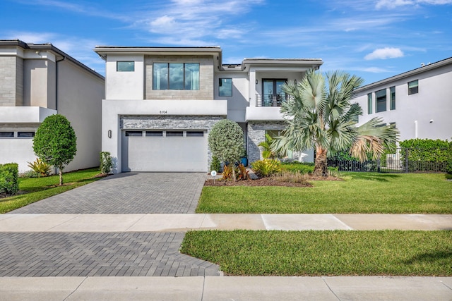 contemporary home with a front yard and a garage