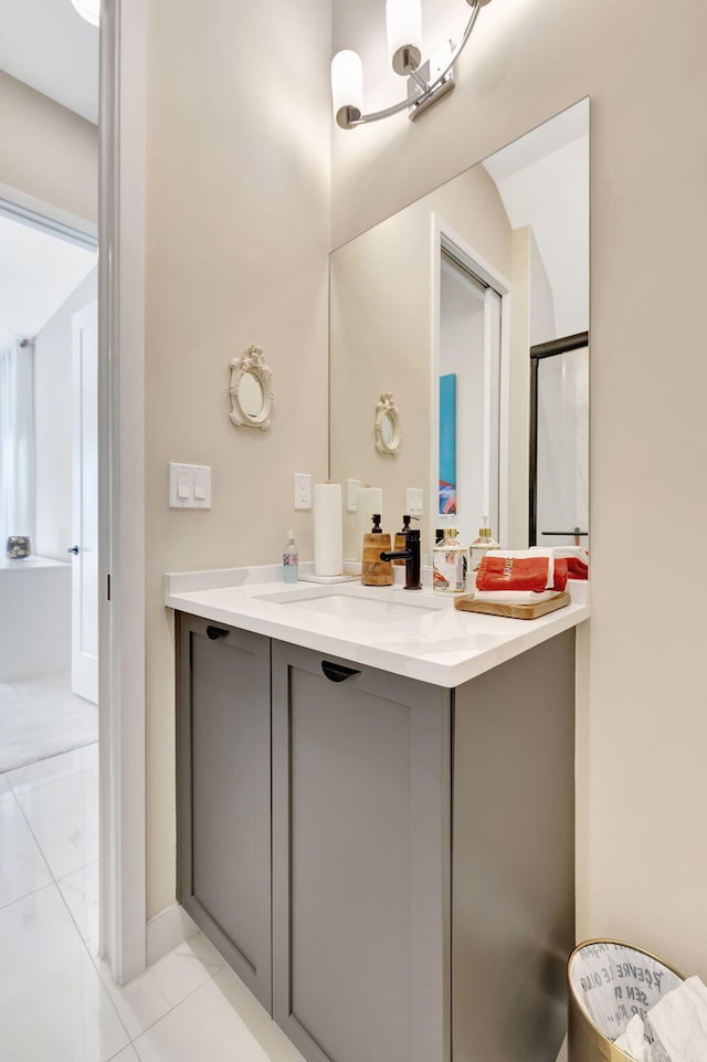 bathroom featuring vanity, a shower with shower door, and tile patterned flooring