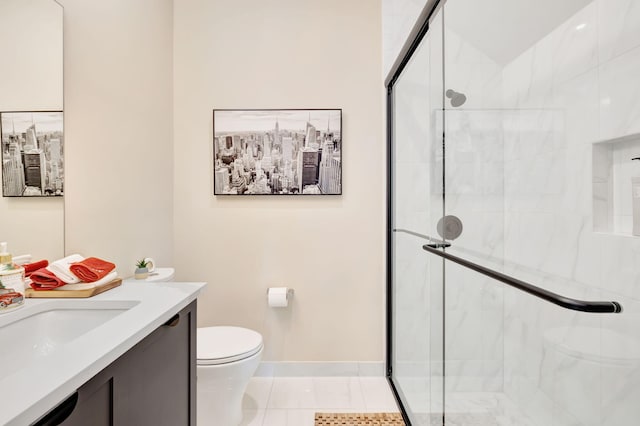 bathroom featuring a shower with door, vanity, toilet, and tile patterned floors