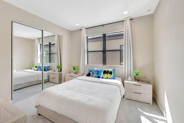 bedroom with a closet and light colored carpet