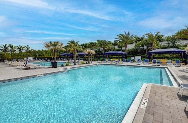 view of swimming pool featuring a patio and a gazebo