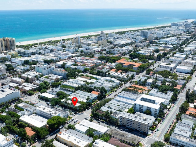 drone / aerial view featuring a view of the beach and a water view