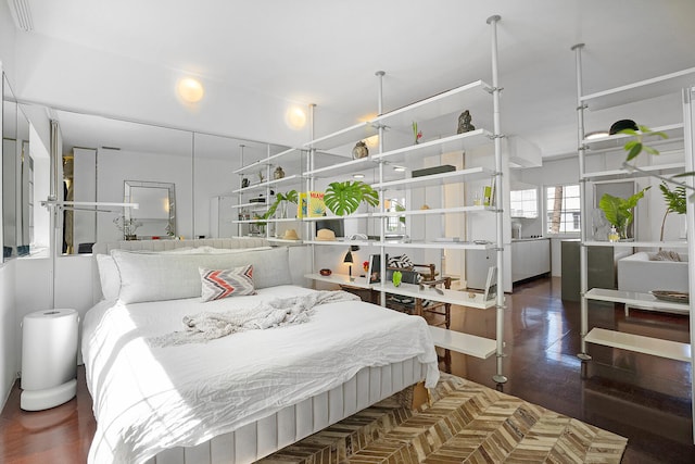 bedroom with dark wood-type flooring