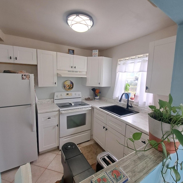 kitchen featuring white cabinets, light tile patterned flooring, sink, and white appliances