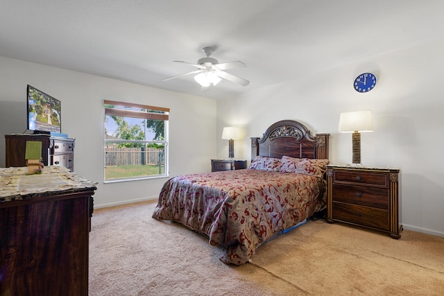 bedroom featuring ceiling fan and light colored carpet