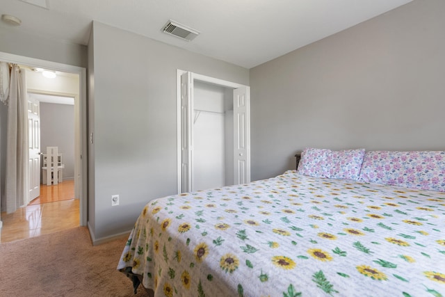 carpeted bedroom with a closet