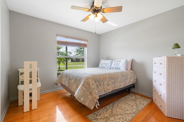 bedroom with light hardwood / wood-style floors and ceiling fan