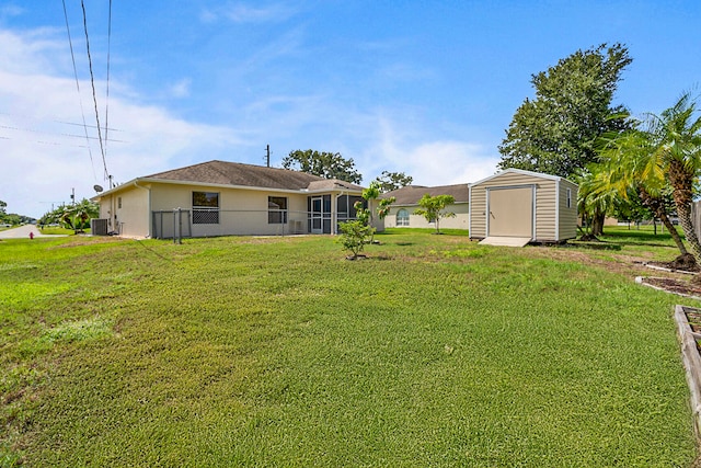 view of yard featuring cooling unit and a storage shed