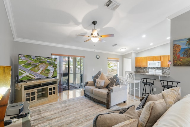 living room with ceiling fan, lofted ceiling, crown molding, and light hardwood / wood-style floors