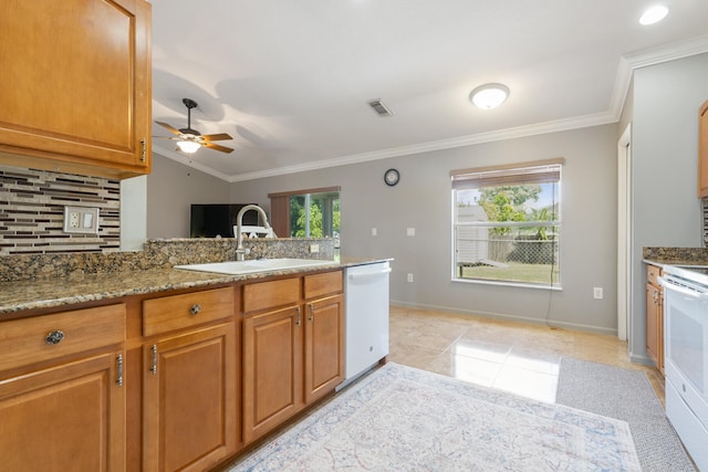 kitchen featuring white appliances, light stone countertops, ceiling fan, ornamental molding, and sink