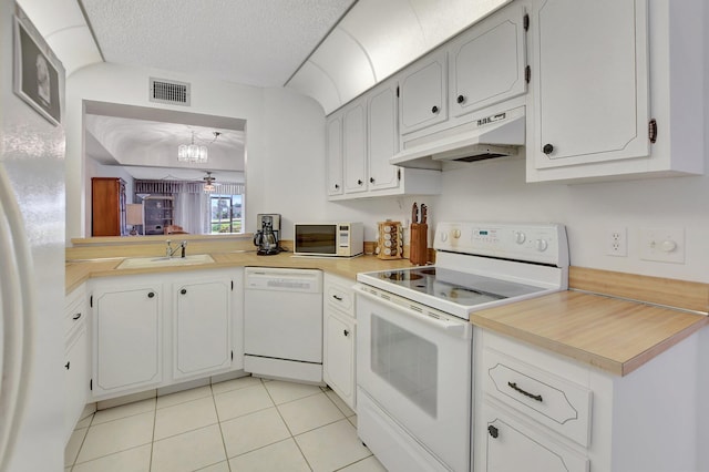 kitchen featuring light tile patterned flooring, a chandelier, white appliances, sink, and white cabinets