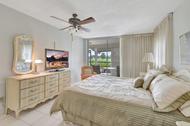 bedroom with access to outside, light tile patterned floors, a textured ceiling, and ceiling fan