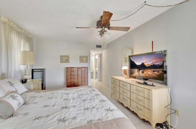 tiled bedroom featuring ceiling fan and a textured ceiling