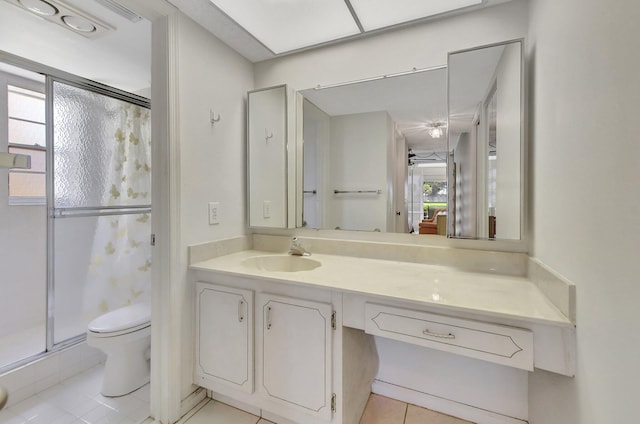 bathroom featuring vanity, tile patterned floors, toilet, and a healthy amount of sunlight