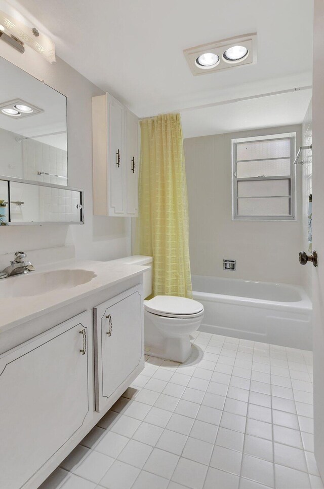 full bathroom with vanity, tile patterned floors, toilet, and shower / bath combo