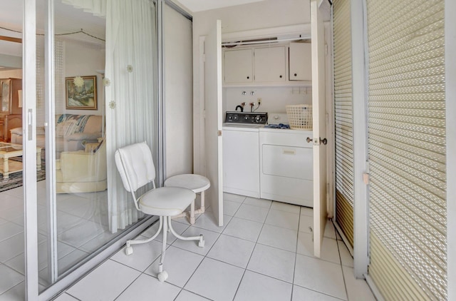 laundry area featuring independent washer and dryer, cabinets, and light tile patterned floors