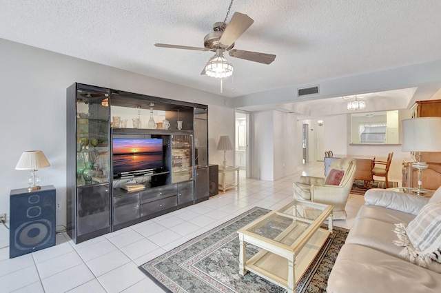 tiled living room featuring ceiling fan and a textured ceiling