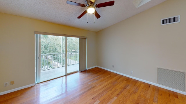 empty room with ceiling fan, light hardwood / wood-style floors, and a textured ceiling